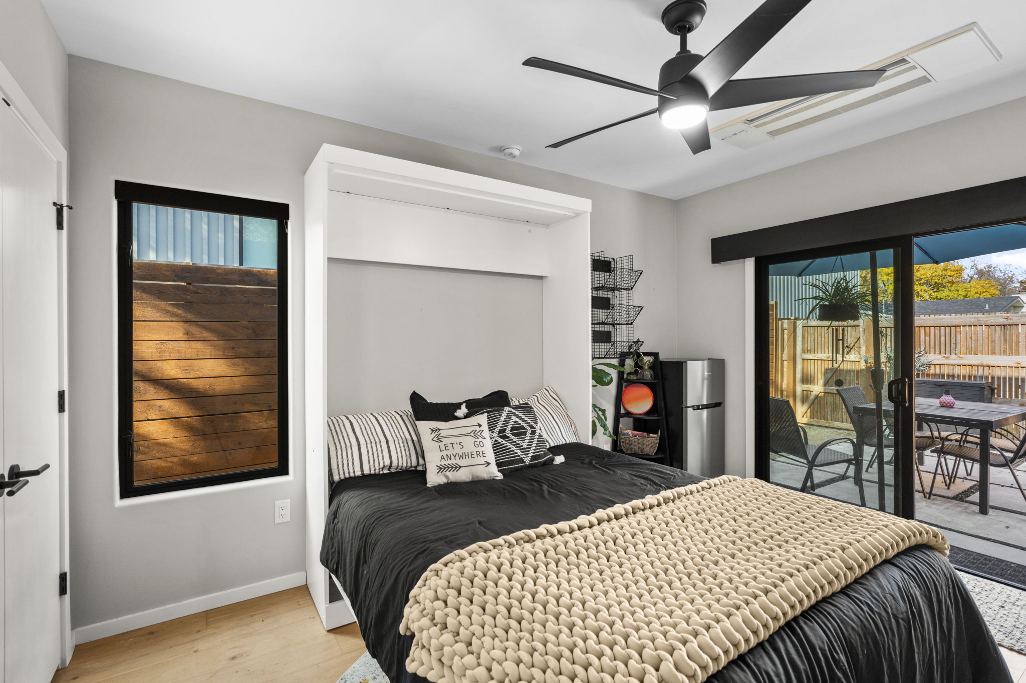 7525 Delafield Lane, Unit B Austin, TX 78752 - Photo 32 of 37 a bedroom with a bed and glass door