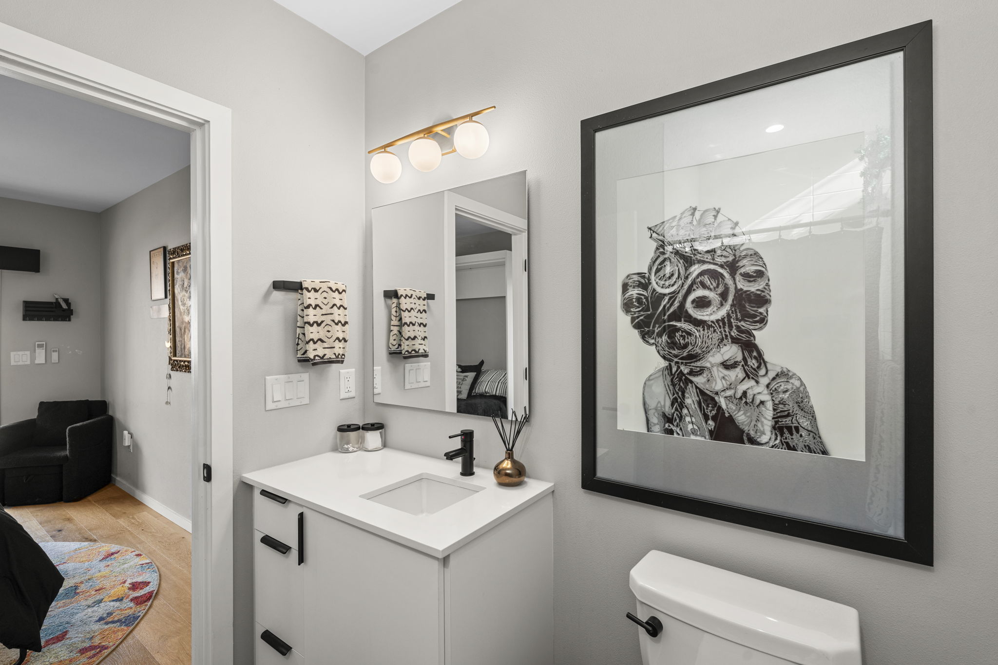 7525 Delafield Lane, Unit B Austin, TX 78752 - Photo 36 of 37 a bathroom with a sink and a mirror