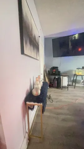 a living room with furniture and flat screen tv