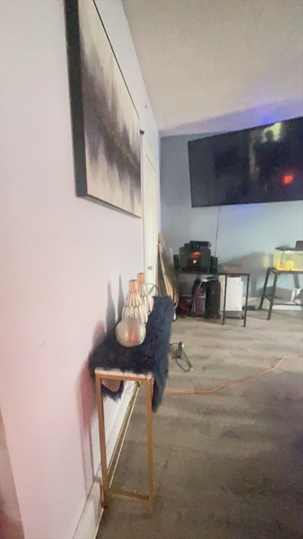 34 Beacon Street, Unit 1L Worcester, MA 01608 - Photo 2 of 9 a living room with furniture and flat screen tv