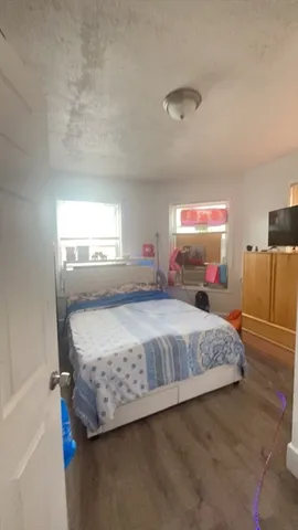 a bedroom with a bed and window