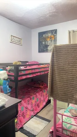 a bedroom with a bed and a painting on the wall