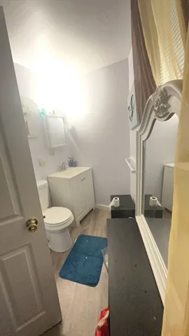 a white toilet sitting next to a bathroom sink and vanity