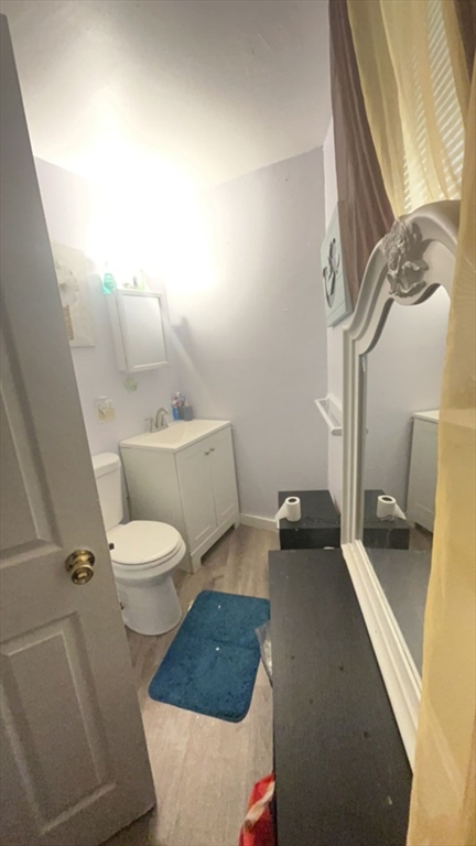 34 Beacon Street, Unit 1L Worcester, MA 01608 - Photo 9 of 9 a white toilet sitting next to a bathroom sink and vanity