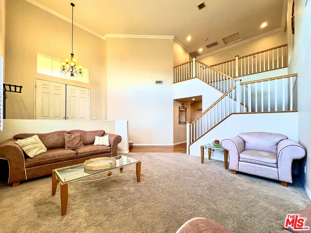 a living room with furniture and a ceiling fan