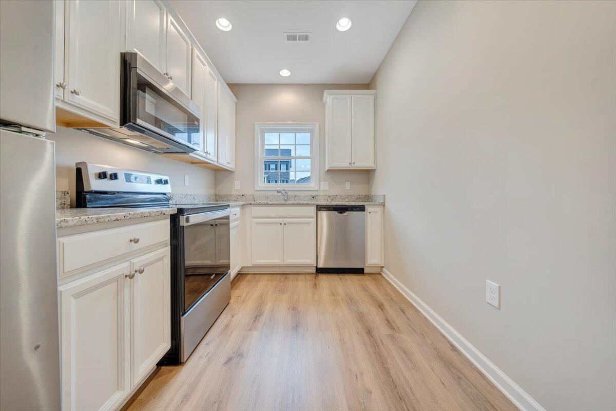 5647 Huntridge Road Roanoke, VA 24019 - Photo 10 of 19 a kitchen with granite countertop a sink cabinets stainless steel appliances and a counter space