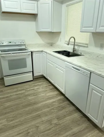 a kitchen with a sink and cabinets