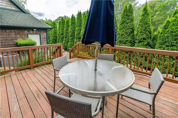 a balcony with table and chairs