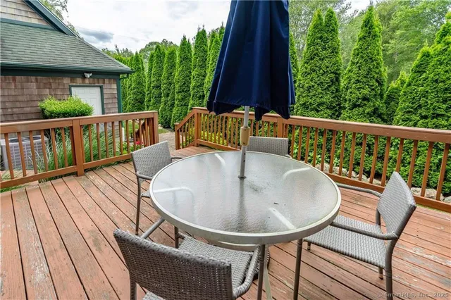 a balcony with table and chairs