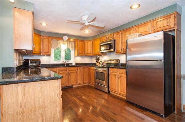 327 Sterling Road Holden, MA 01522 - Photo 3 of 30 a kitchen with a refrigerator a sink stainless steel appliances cabinets and a large window