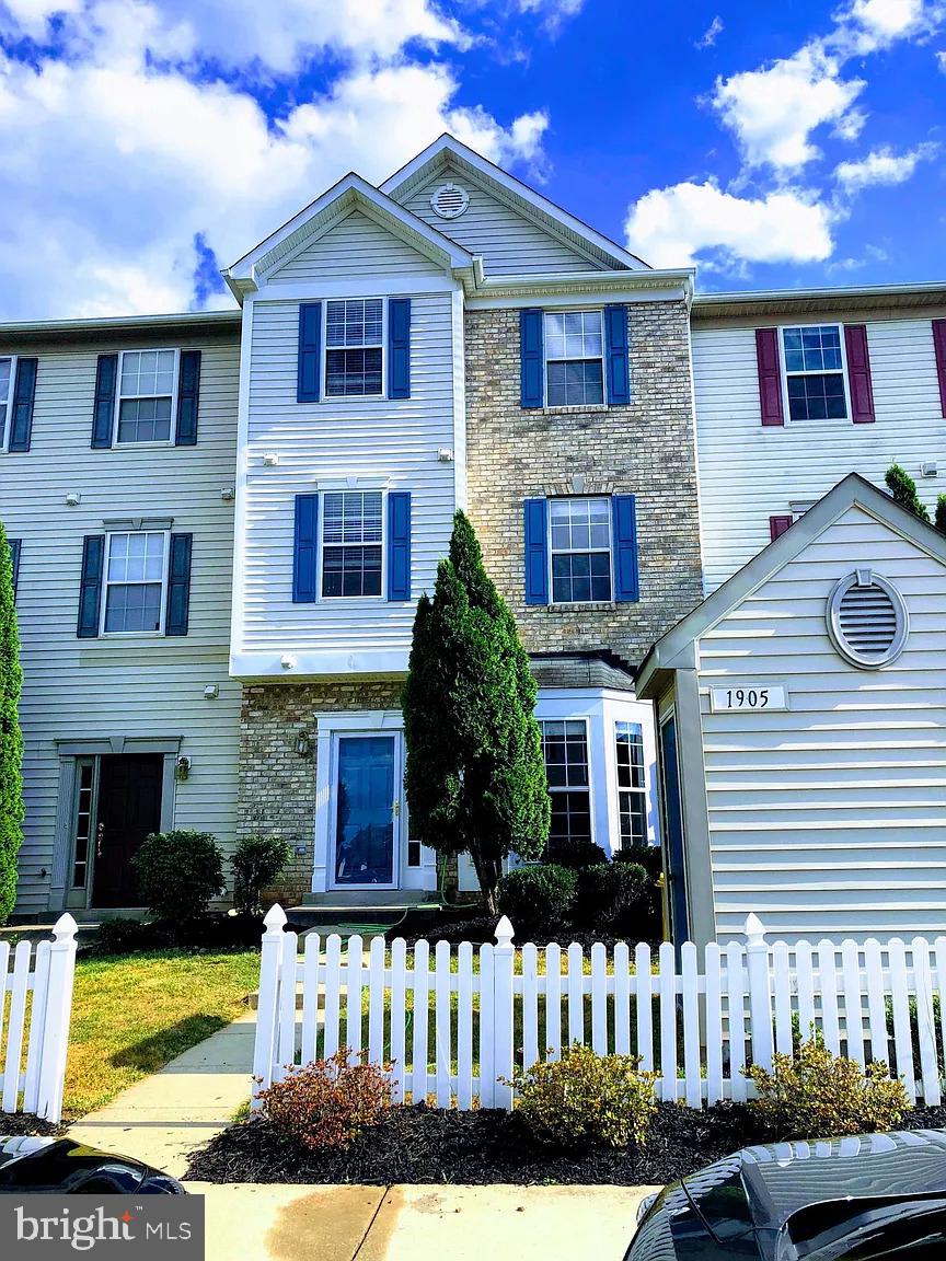a front view of a house with yard and garage