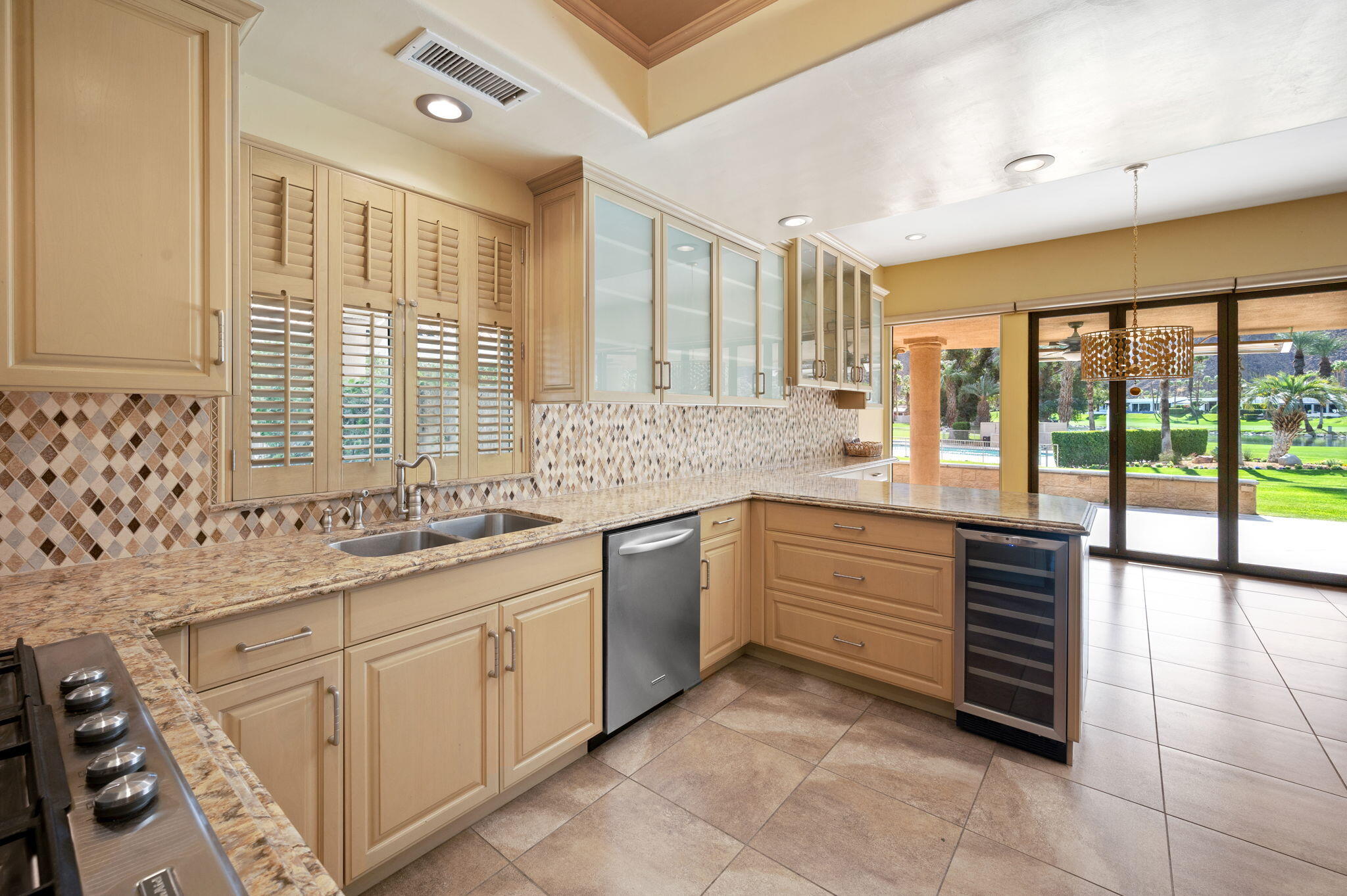 77675 Seminole Road Indian Wells, CA 92210 - Photo 12 of 40 a kitchen with stainless steel appliances sink cabinets and window