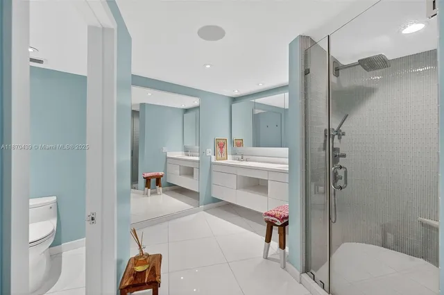 a bedroom with two beds and a view of bedroom