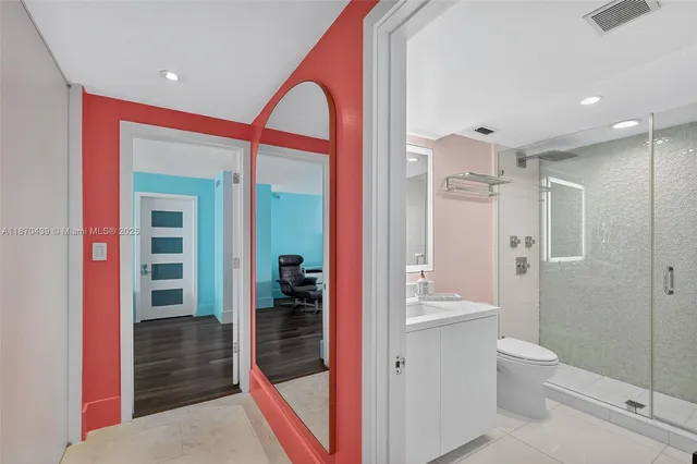 a bathroom with a shower and a glass door