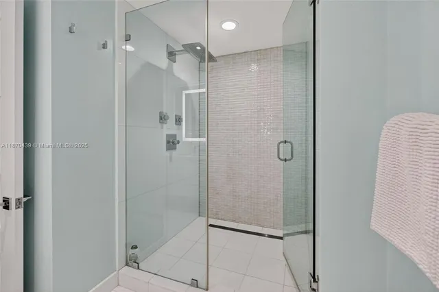 a view of a kitchen with refrigerator and dining table
