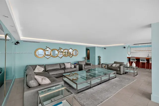 a living room with furniture and a floor to ceiling window