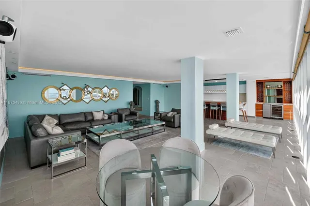 a living room with furniture and large window