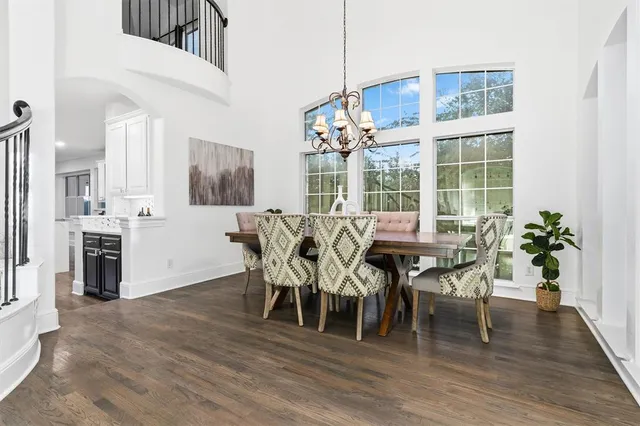 a dining room with furniture entryway and wooden floor