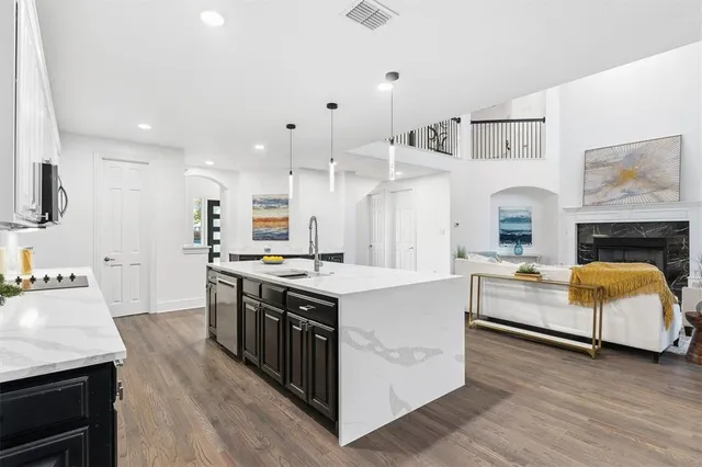 a open kitchen with cabinets a sink and a stove