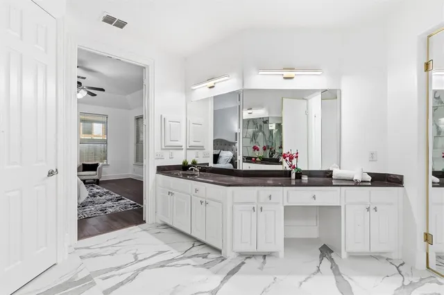 a spacious bathroom with a sink and a mirror