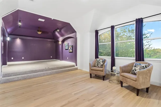 a spacious bedroom with a bed and glass windows