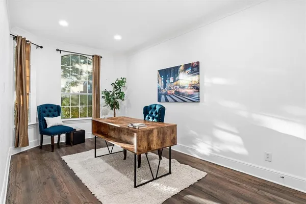 a work room with furniture and wooden floor