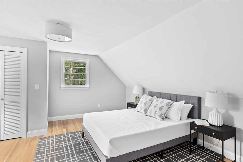 14 Spring Street Hingham, MA 02043 - Photo 18 of 28 a bedroom with a bed and a window