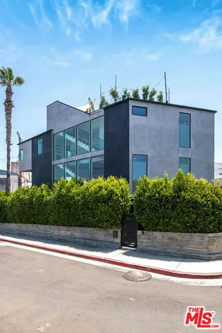 a view of a brick house next to a yard