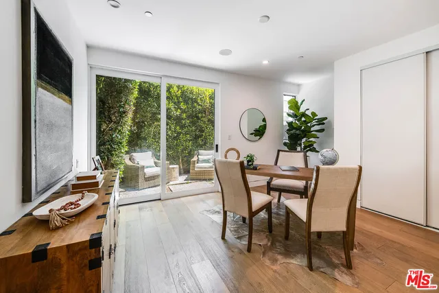 a dining room with furniture and wooden floor