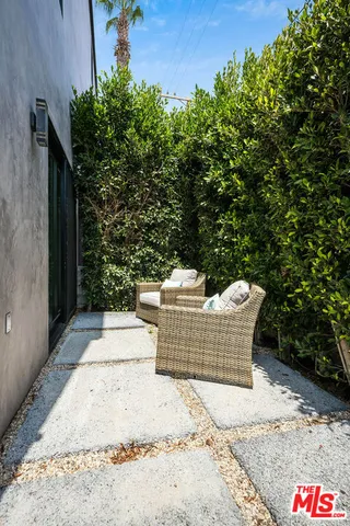 a view of a street with potted plants