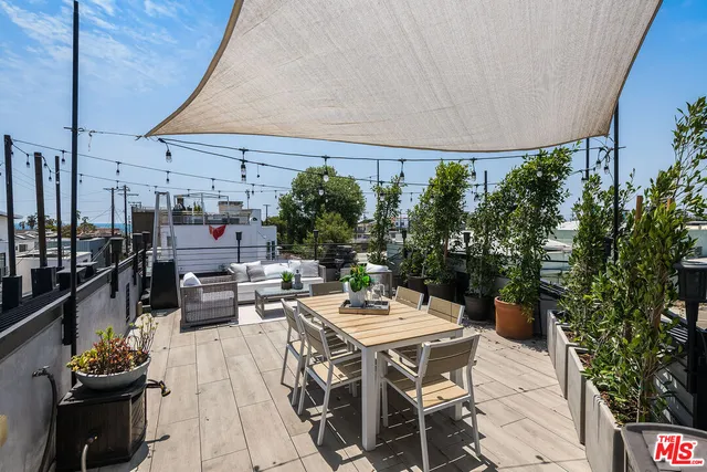 a dinning table and chairs in patio of a house