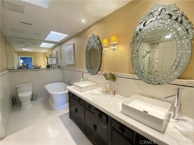 a spacious bathroom with a double vanity sink and a mirror