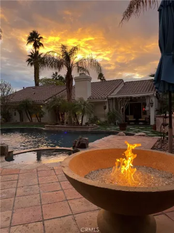 a view of swimming pool with a lounge chairs