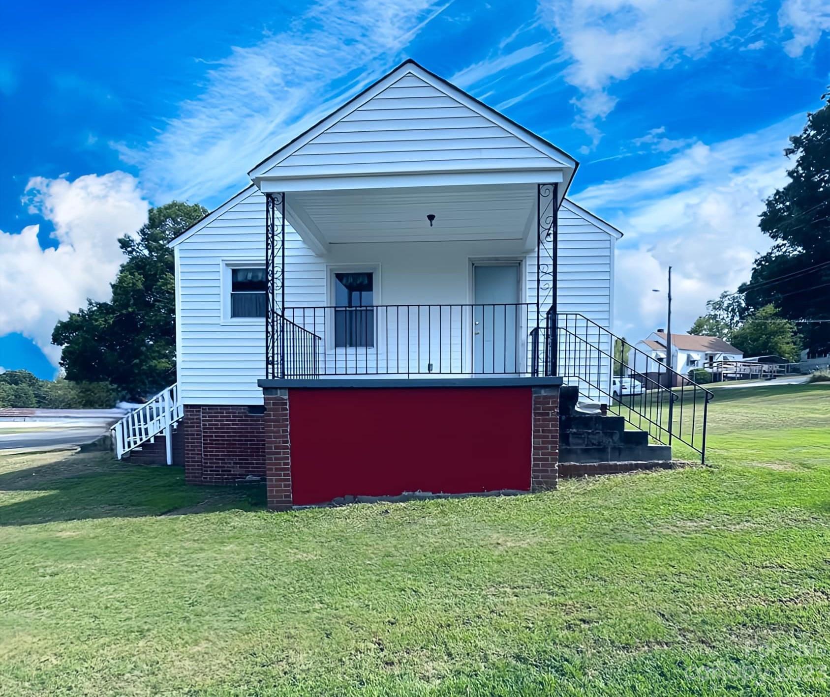 a view of backyard of house with outdoor seating