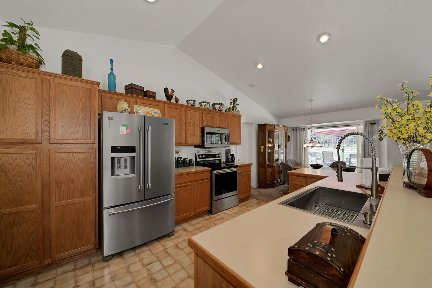 52311 Ammon Road La Pine, OR 97739 - Photo 15 of 39 a large kitchen with a refrigerator a stove top oven a sink and dishwasher