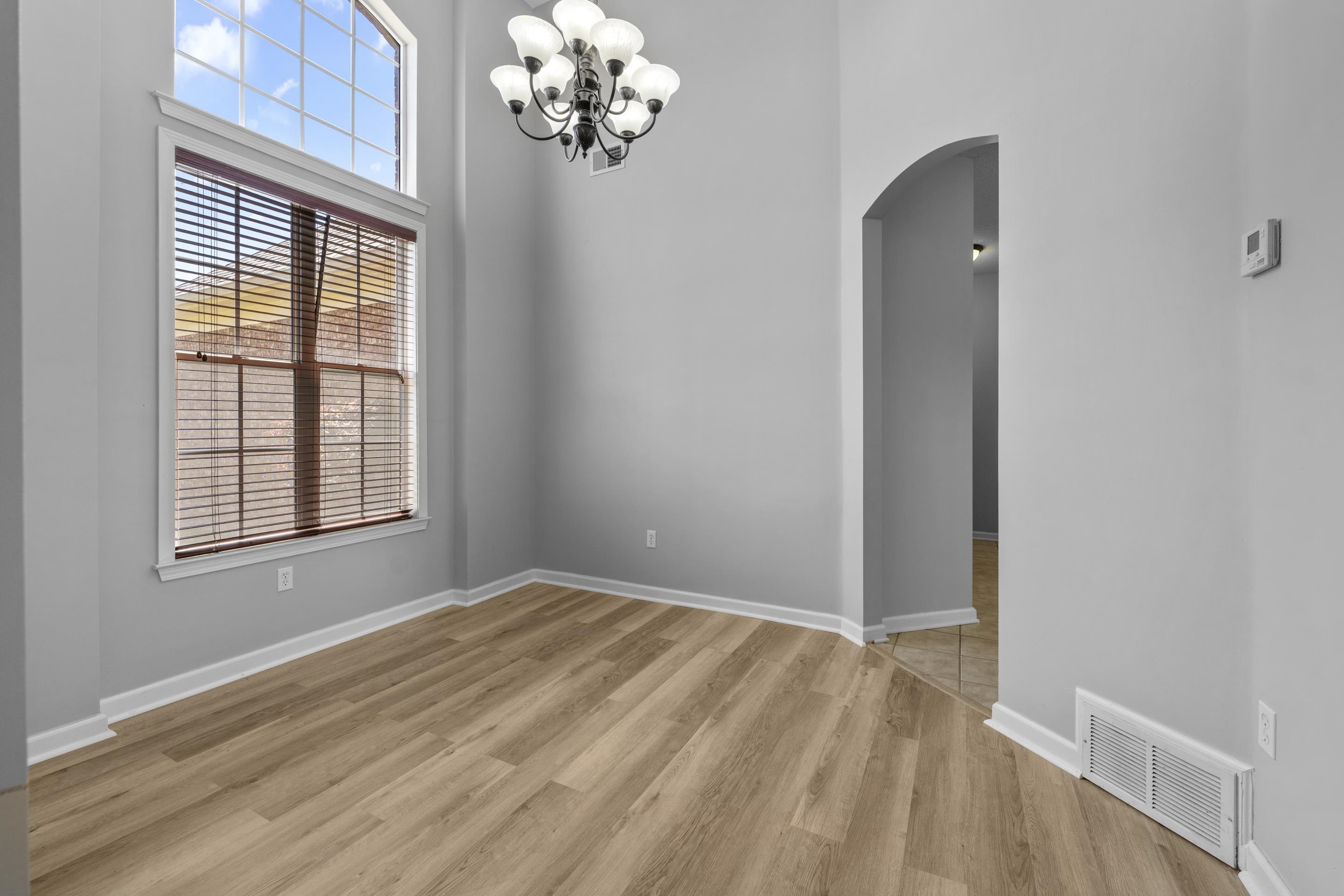 50 Abbey Road Oakland, TN 38060 - Photo 12 of 26 Vaulted ceiling accenting a multi-pane arched window with louvered blinds