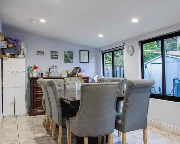 a dining room with furniture and window