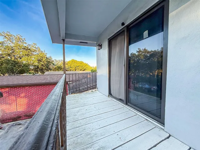 a balcony with view of an outdoor space