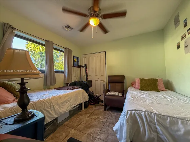a bedroom with a bed lamps and window