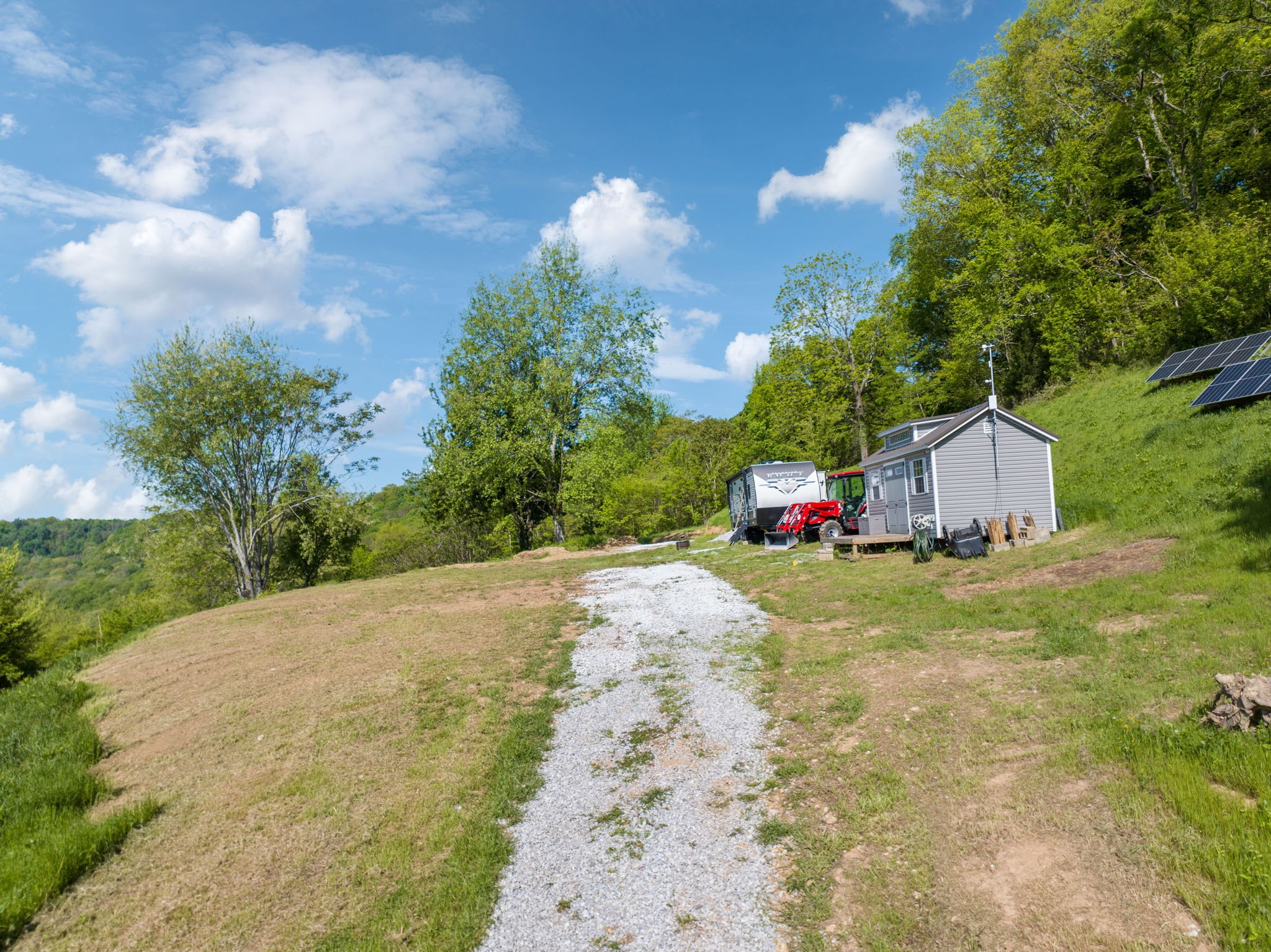 40 Hackett Valley Road Hickman, TN 38567 - Photo 13 of 26 a backyard of a house with table and chairs plants and large tree