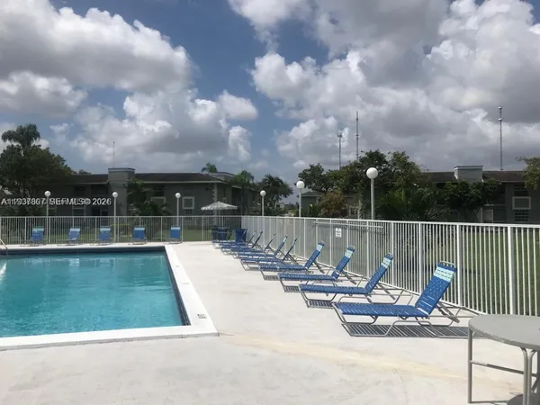 a view of swimming pool having outdoor seating