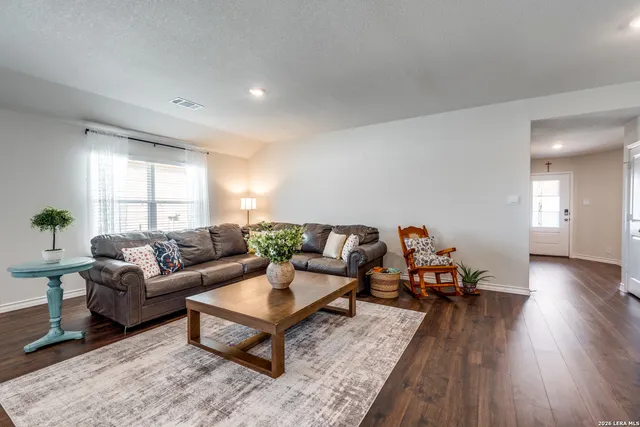 a living room with furniture and wooden floor