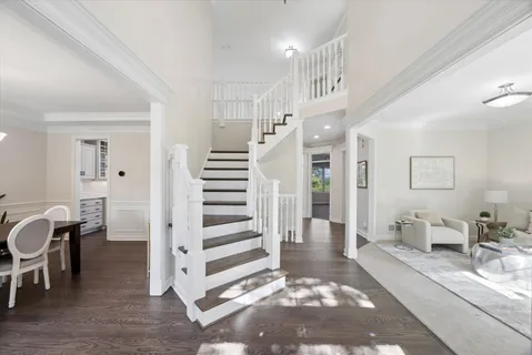a view of a hallway with dining room and stairs