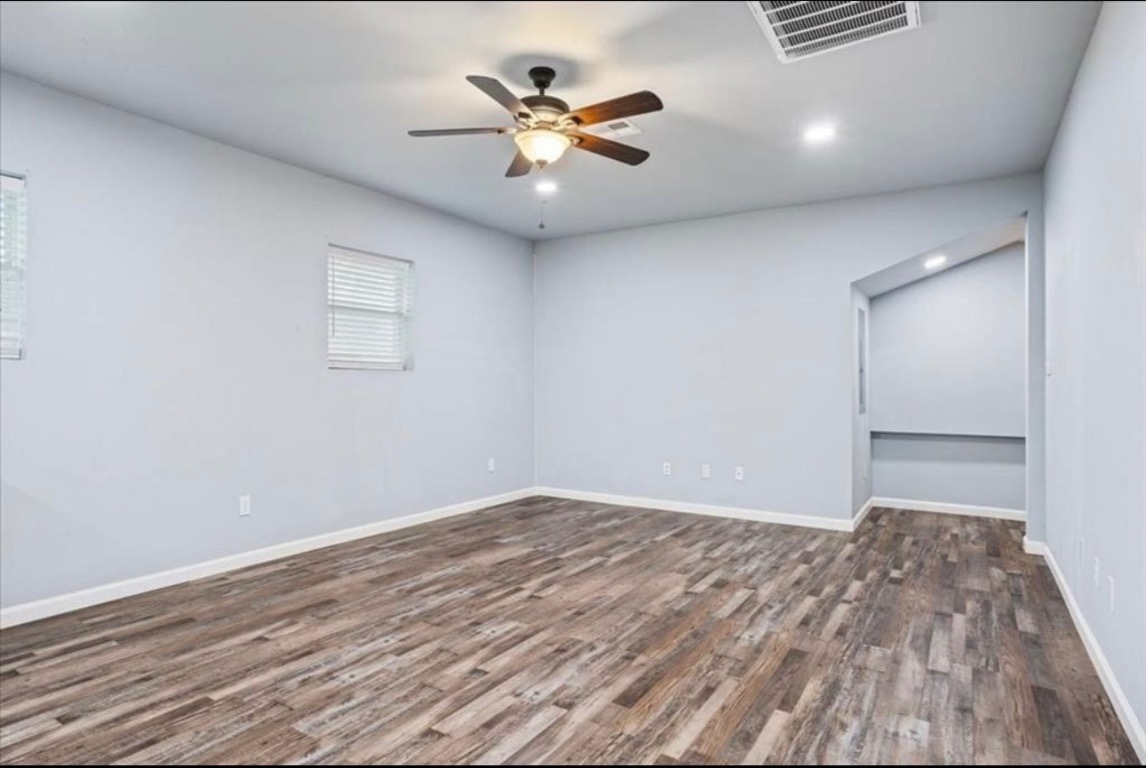 117 Emma Street, Unit B Bartlett, TX 76511 - Photo 14 of 18 an empty room with a ceiling fan and wooden floor