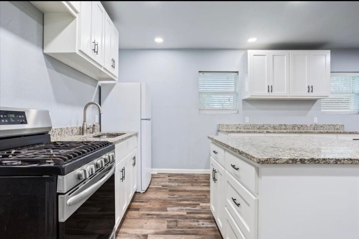117 Emma Street, Unit B Bartlett, TX 76511 - Photo 2 of 18 a kitchen with granite countertop a stove and a sink