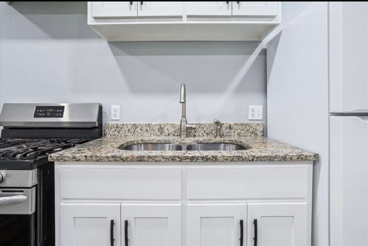 117 Emma Street, Unit B Bartlett, TX 76511 - Photo 6 of 18 a kitchen with a sink and a refrigerator