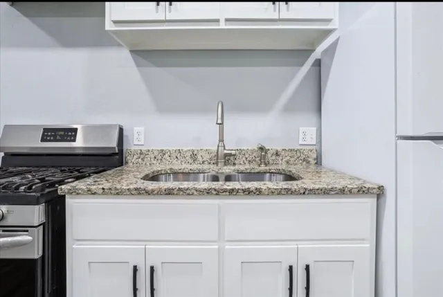 a kitchen with a sink and a refrigerator