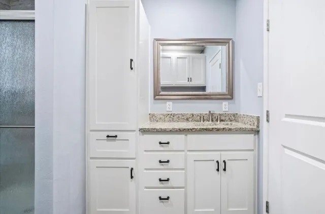 a bathroom with a sink and a mirror