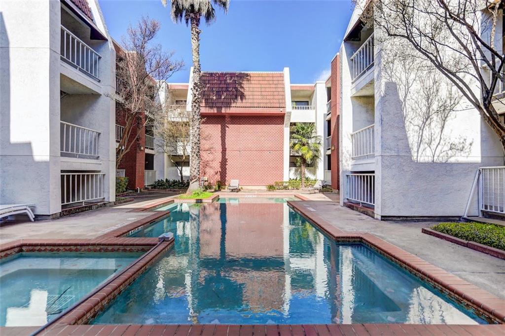 3115 Helms Street, Unit 204 Austin, TX 78705 - Photo 11 of 13 A tranquil community pool, framed by apartment buildings, offers a serene escape.