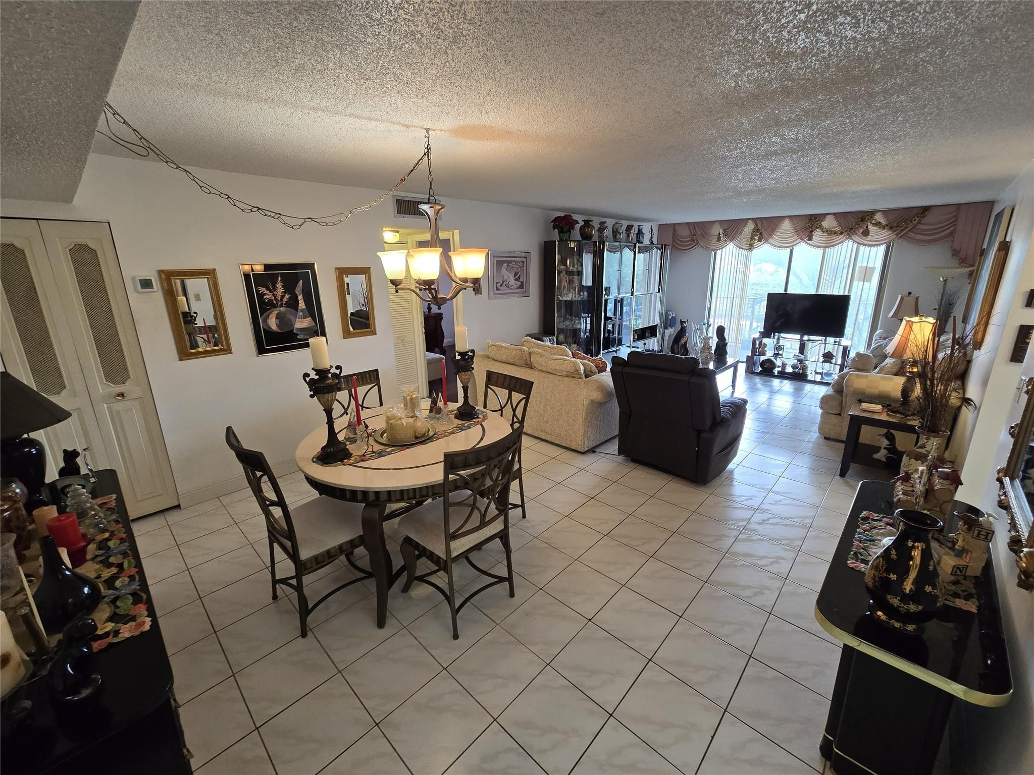 6195 Rock Island Road, Unit 215 Tamarac, FL 33319 - Photo 12 of 37 a view of a dining room with furniture